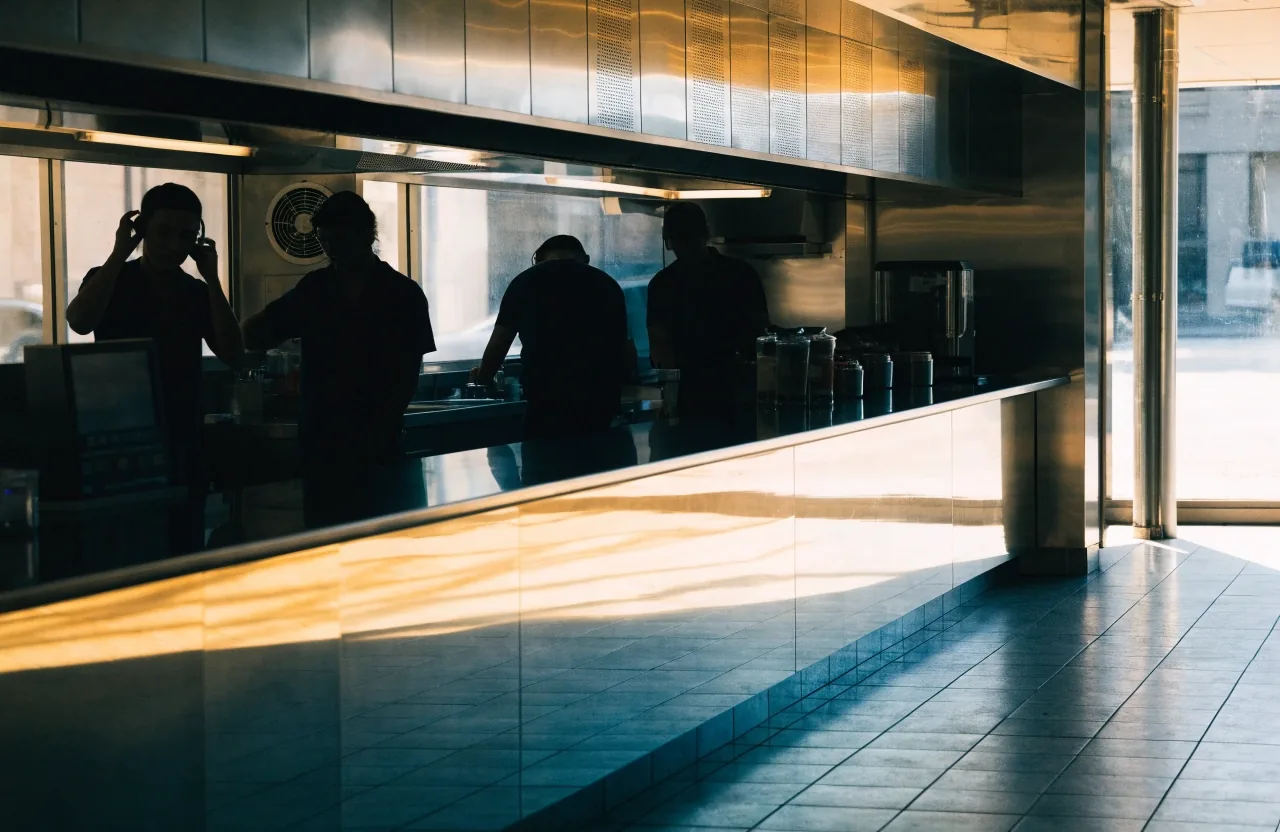 Empty franchise dining room before opening with stacked chairs against the wall
